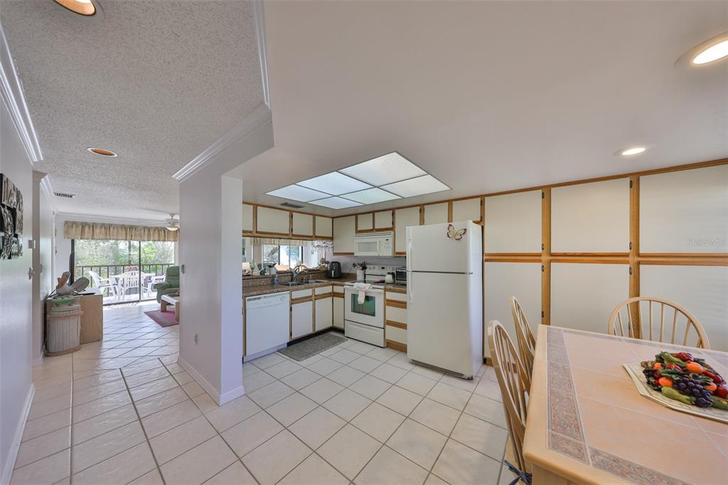 6123 113th Street, Unit 510 Seminole, FL 33772 - Photo 3 of 44 a kitchen with stainless steel appliances granite countertop a refrigerator and a stove top oven