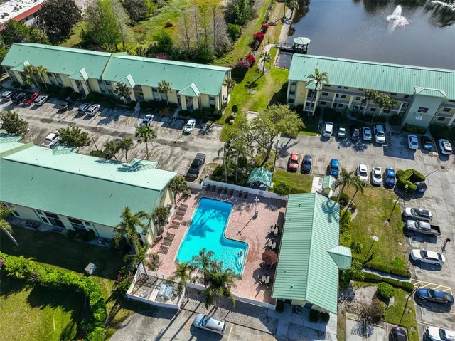 an aerial view of a house with a yard and lake view