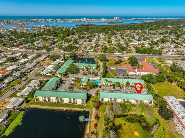 an aerial view of residential building and car parked on street side