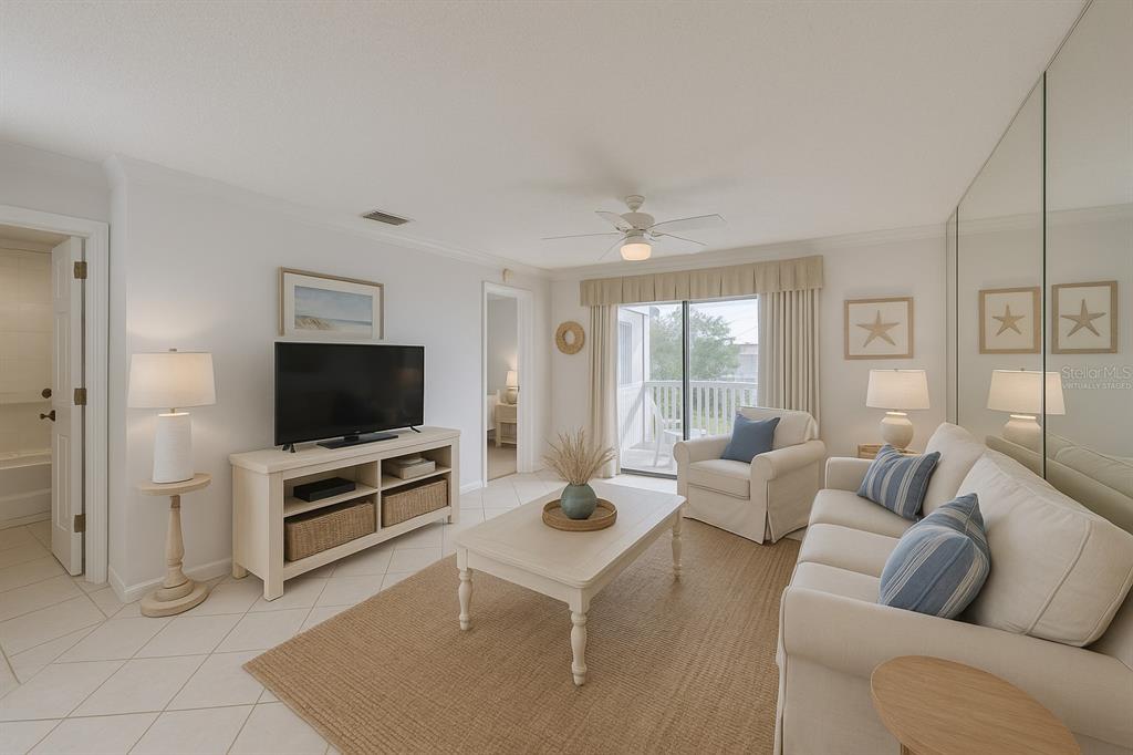 6123 113th Street, Unit 510 Seminole, FL 33772 - Photo 42 of 44 a living room with furniture and a flat screen tv