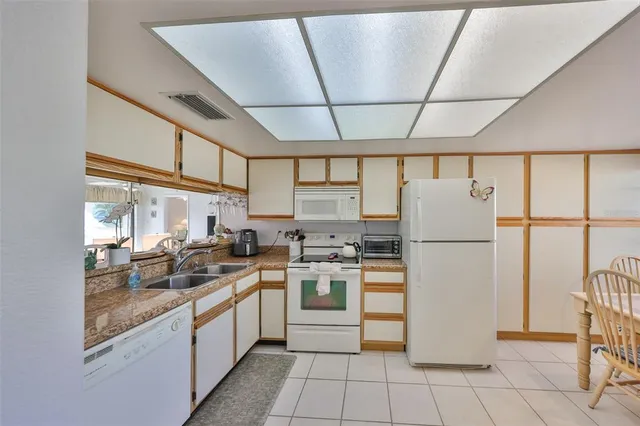 a kitchen with a refrigerator a stove and a sink