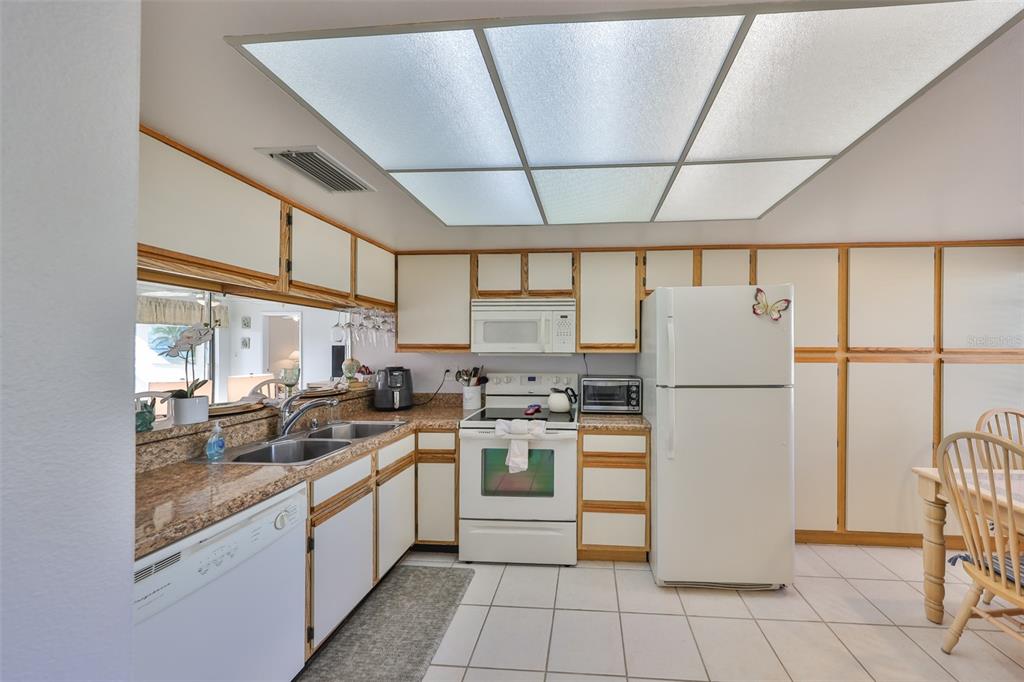 6123 113th Street, Unit 510 Seminole, FL 33772 - Photo 5 of 44 a kitchen with a refrigerator a stove and a sink