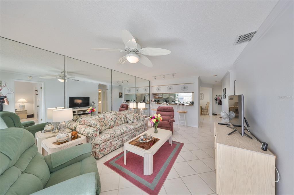 6123 113th Street, Unit 510 Seminole, FL 33772 - Photo 9 of 44 a living room with furniture kitchen view and a chandelier
