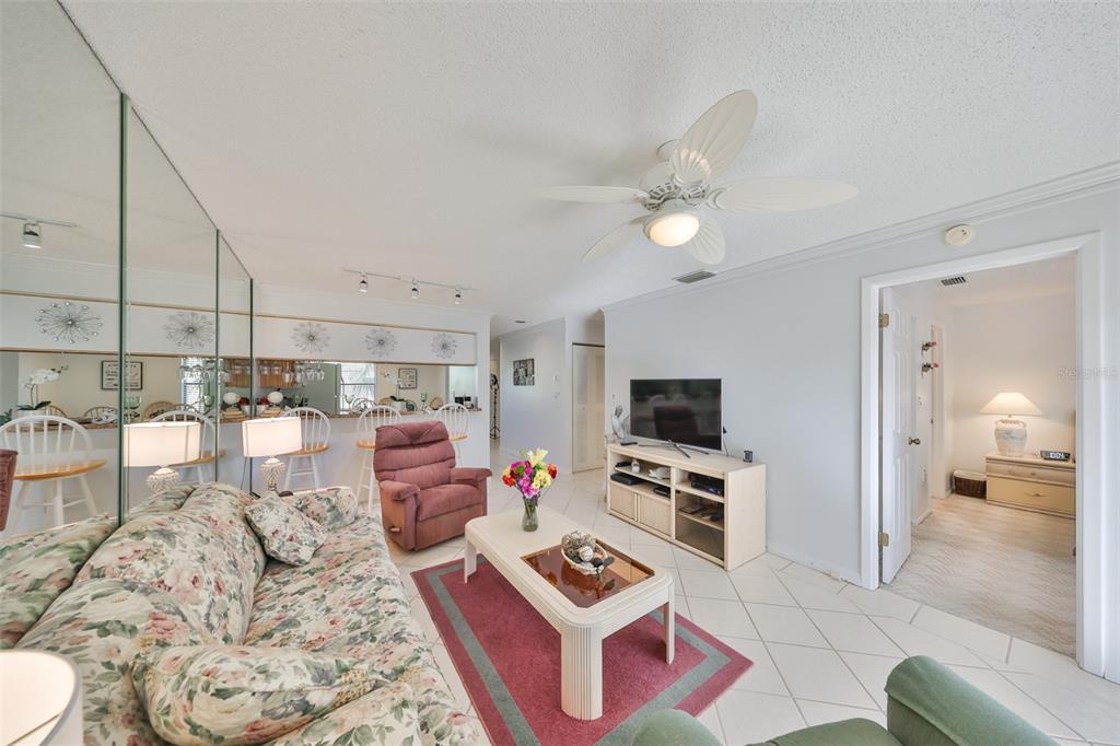 6123 113th Street, Unit 510 Seminole, FL 33772 - Photo 10 of 44 a living room with furniture and a flat screen tv