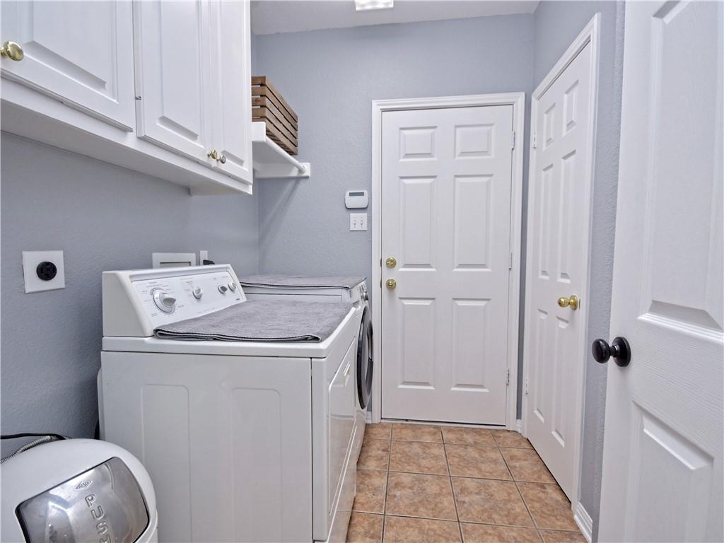 9216 Evening Primrose Path Austin, TX 78750 - Photo 15 of 30 a utility room with cabinets washer and dryer