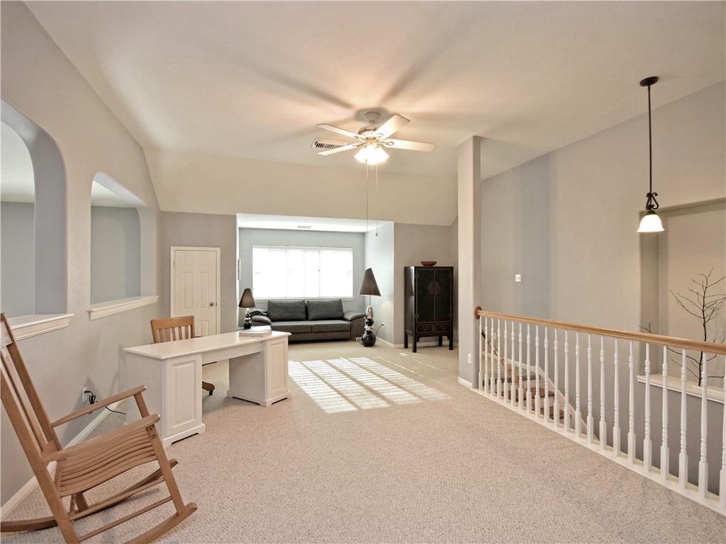 9216 Evening Primrose Path Austin, TX 78750 - Photo 16 of 30 a living room with furniture a chandelier and a window