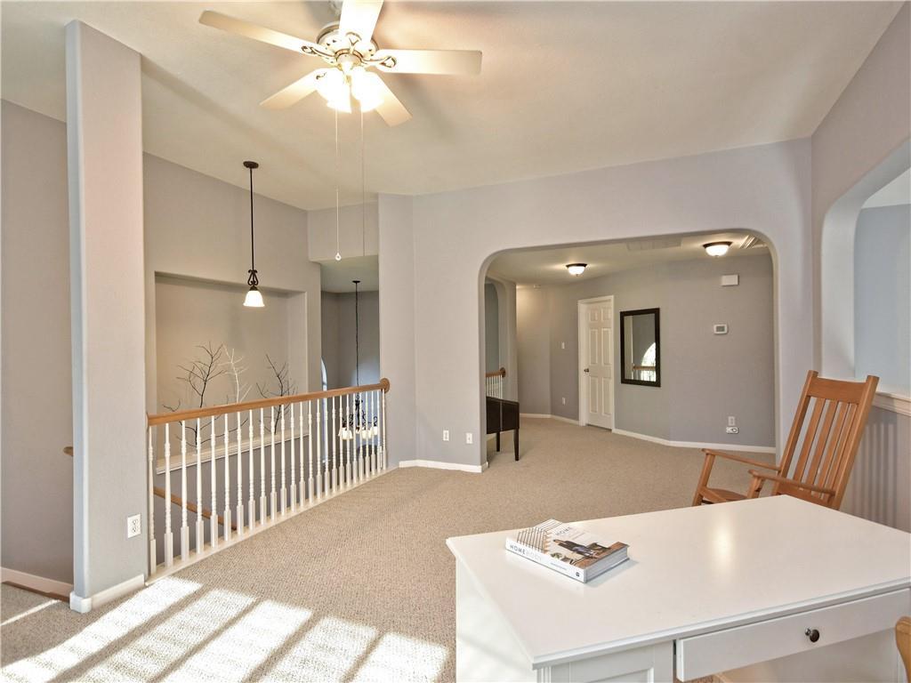 9216 Evening Primrose Path Austin, TX 78750 - Photo 17 of 30 a view of a hallway with furniture and a chandelier fan