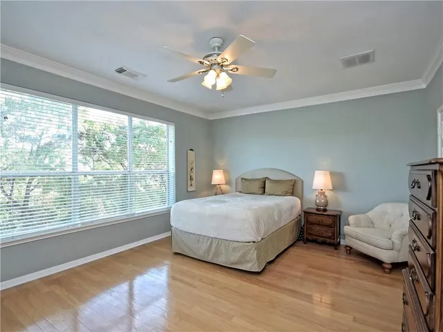 a view of a hallway with furniture and a chandelier fan