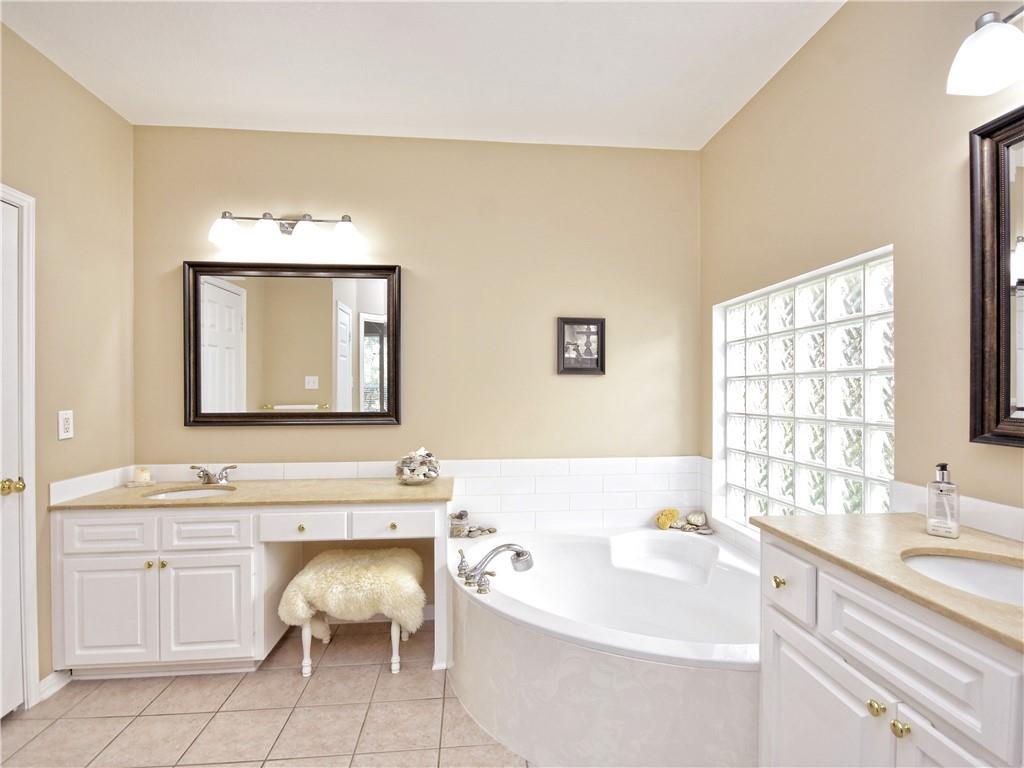 9216 Evening Primrose Path Austin, TX 78750 - Photo 20 of 31 a bathroom with a sink vanity tub and a toilet