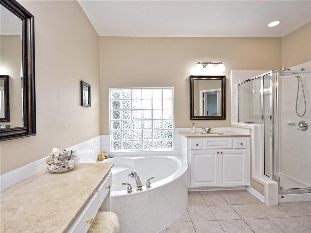 9216 Evening Primrose Path Austin, TX 78750 - Photo 21 of 30 a spacious bathroom with a tub sink and mirror