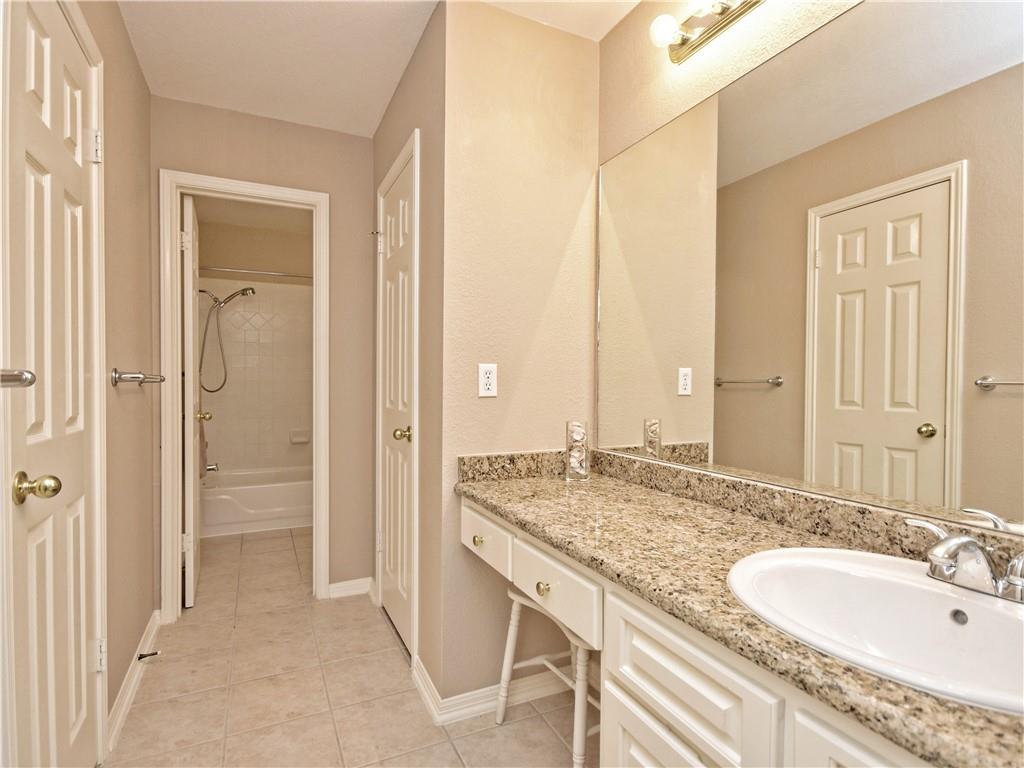 9216 Evening Primrose Path Austin, TX 78750 - Photo 23 of 30 a bathroom with a granite countertop sink and a mirror