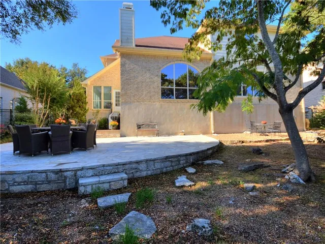 a view of a patio with dining table and chairs