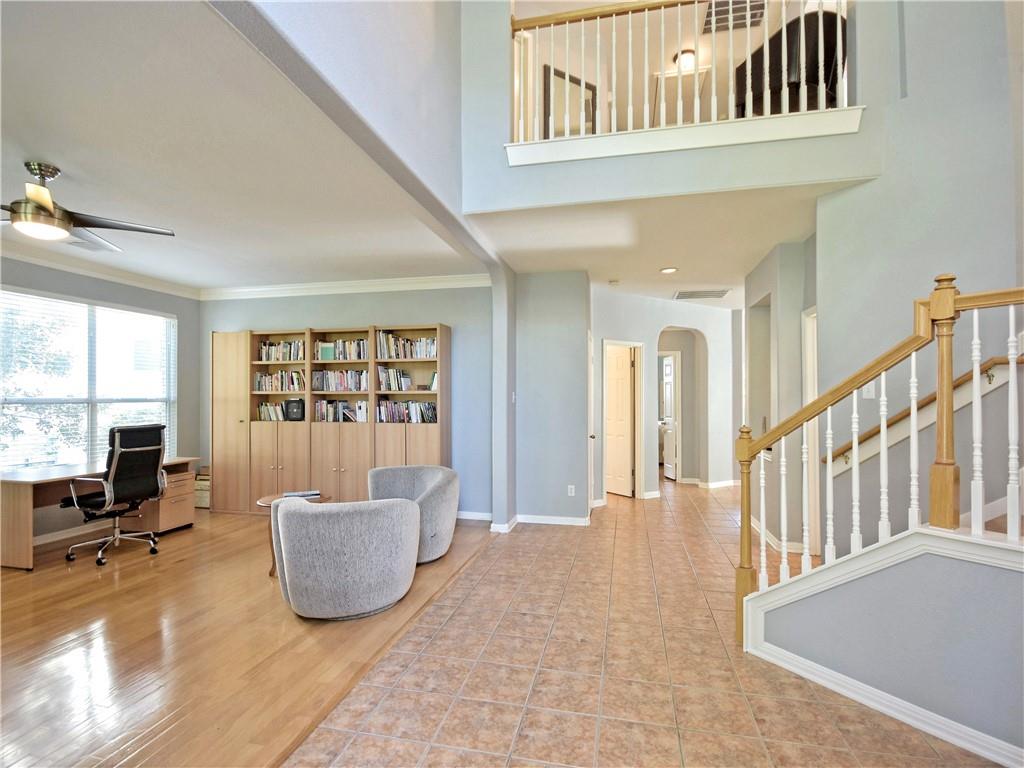 9216 Evening Primrose Path Austin, TX 78750 - Photo 5 of 30 a view of an empty room with wooden floor and a window
