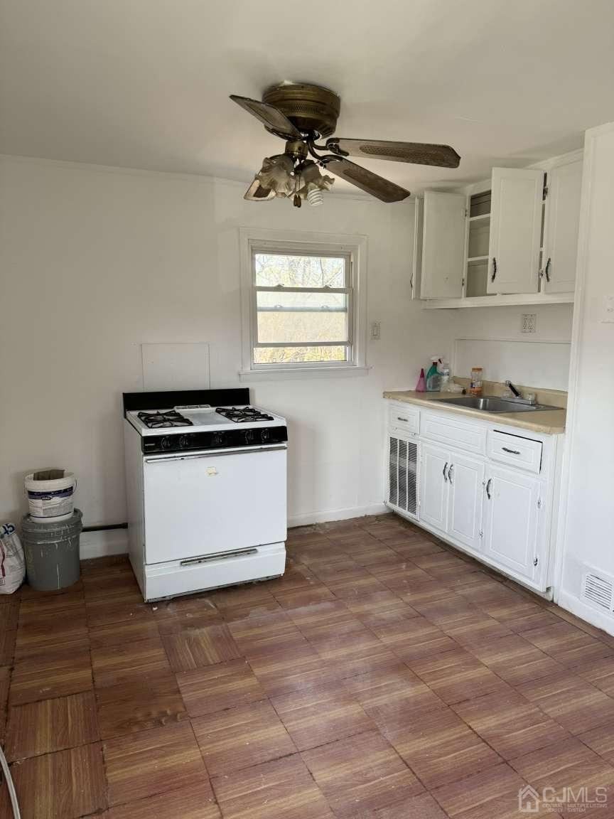 22 Sine Road Edison, NJ 08817 - Photo 13 of 19 a kitchen with a stove cabinets and a window