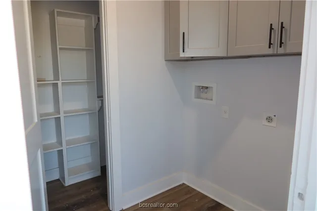 a view of storage and utility room with wooden floor