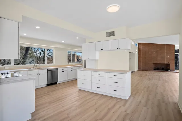 a kitchen with white cabinets and white appliances