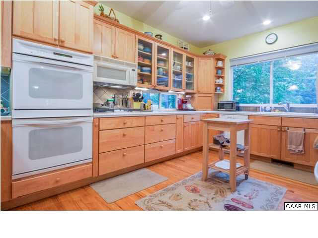 60 Roslyn Heights Road Charlottesville, VA 22901 - Photo 22 of 40 a kitchen with stainless steel appliances granite countertop a stove a sink and cabinets
