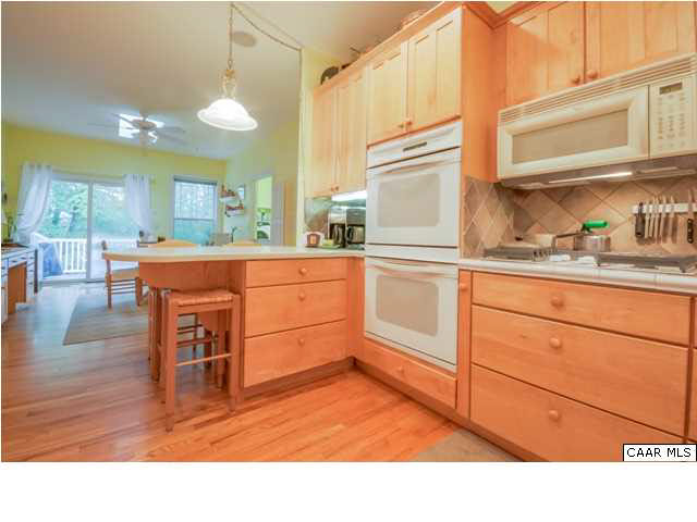 60 Roslyn Heights Road Charlottesville, VA 22901 - Photo 23 of 40 a kitchen with stainless steel appliances granite countertop a stove a sink dishwasher and cabinets with wooden floor