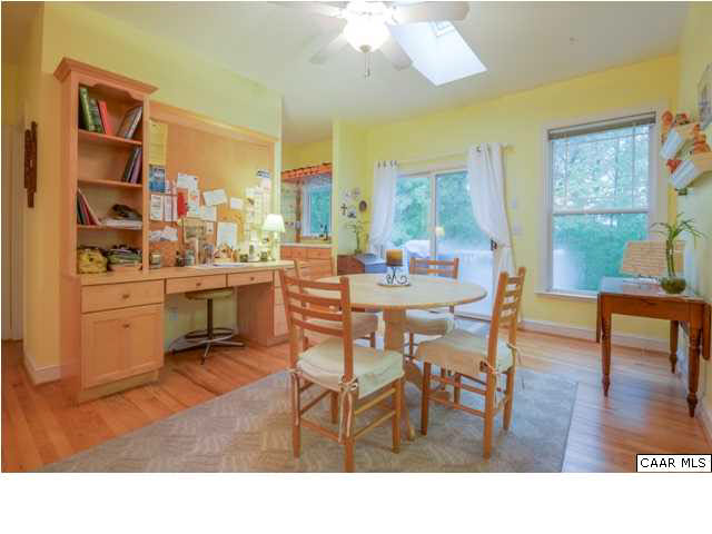 60 Roslyn Heights Road Charlottesville, VA 22901 - Photo 26 of 40 a living room with stainless steel appliances a dining table wooden floor and a large window