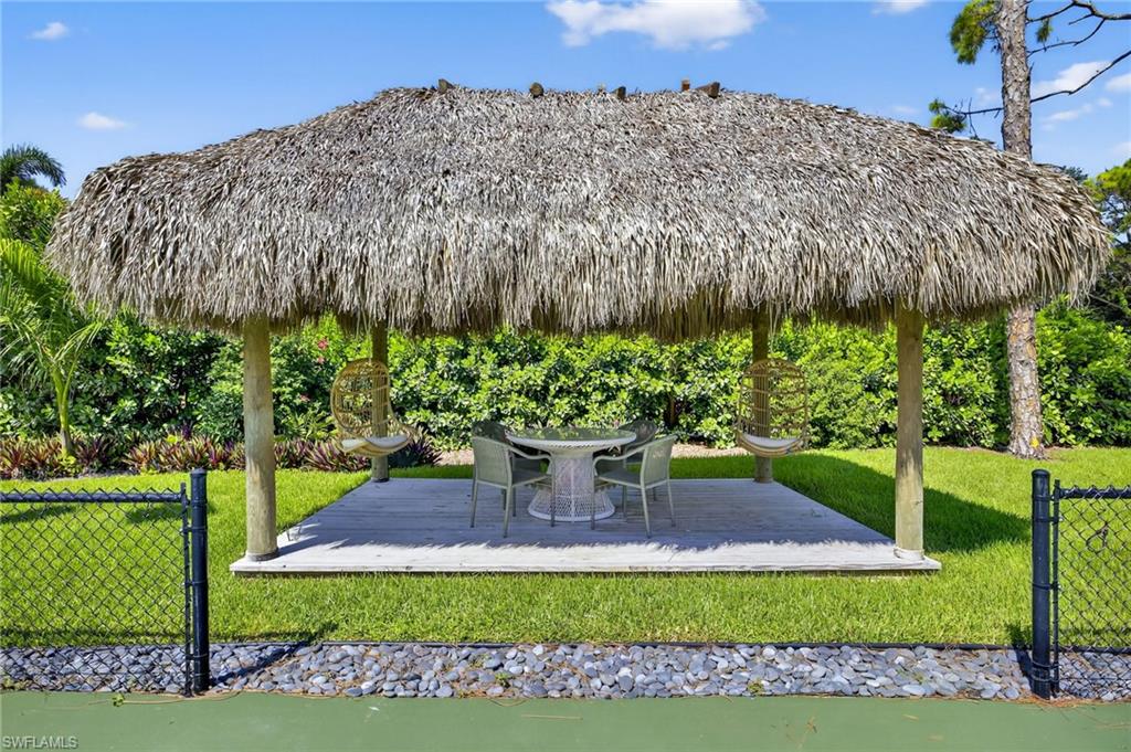 111 Caribbean Road Naples, FL 34108 - Photo 8 of 50 a view of a garden with a bench in a garden