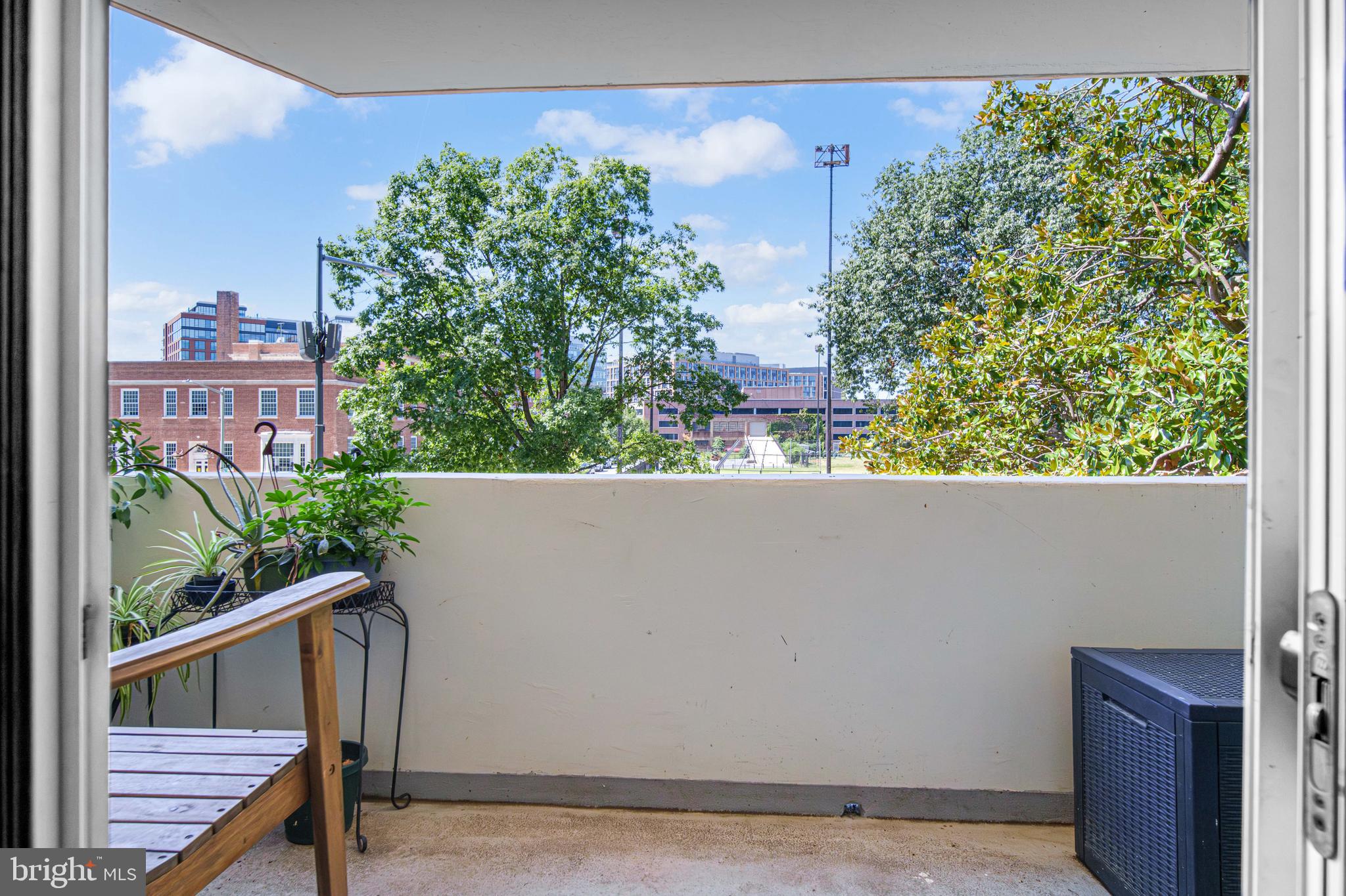 700 7th Street Southwest, Unit 119 Washington, DC 20024 - Photo 14 of 31 a view of a balcony with wooden floor and fence