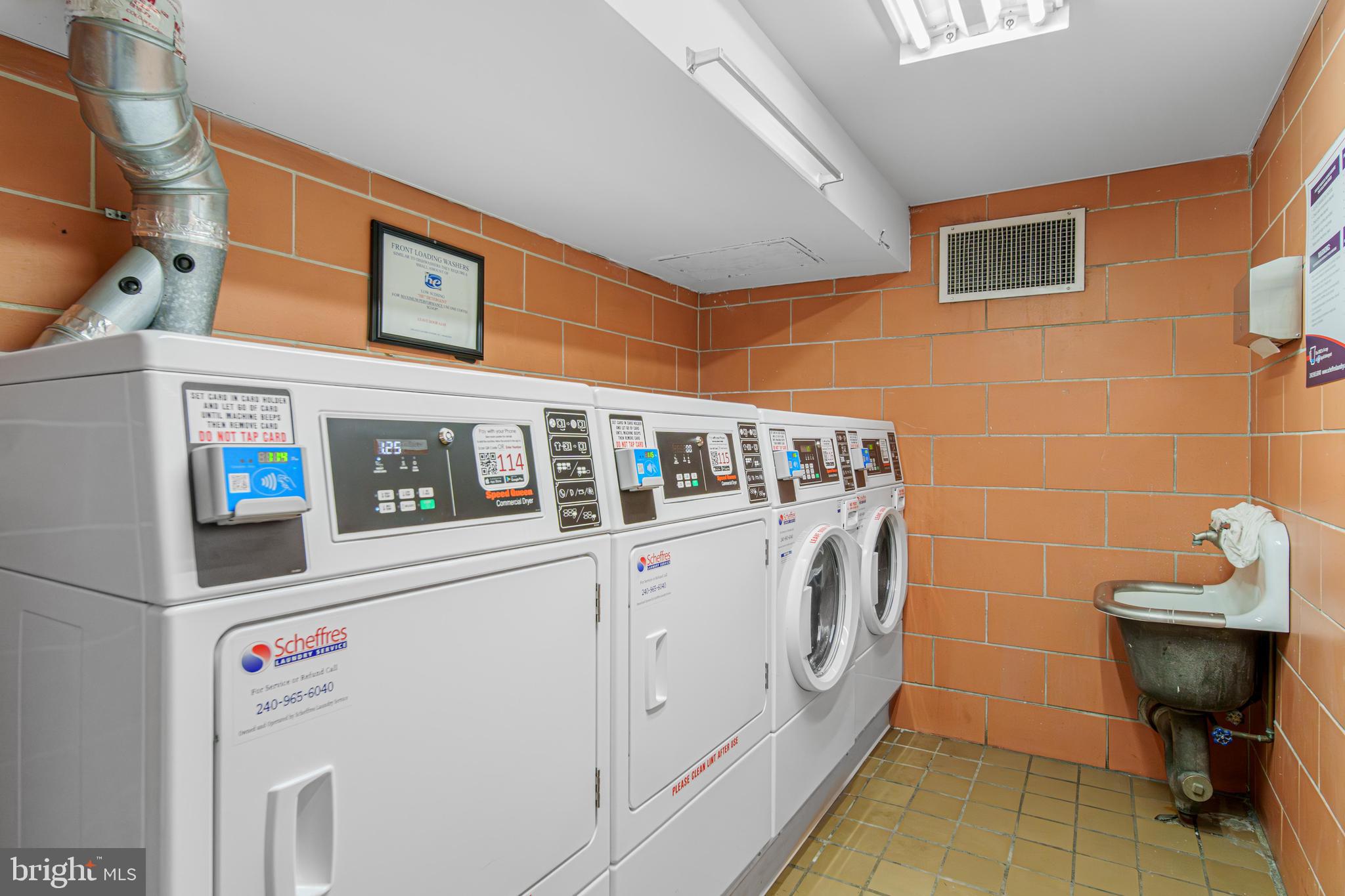 700 7th Street Southwest, Unit 119 Washington, DC 20024 - Photo 15 of 31 a utility room with dryer and washer