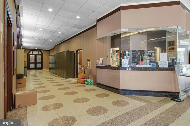 a view of a kitchen with kitchen island a counter top space a sink and cabinets