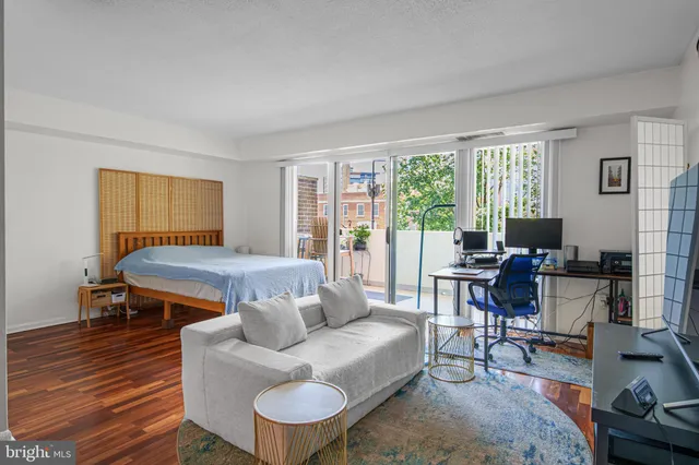 a livingroom with workspace and a couch