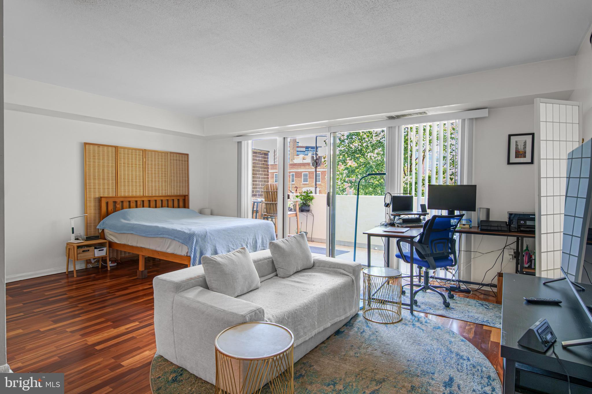 700 7th Street Southwest, Unit 119 Washington, DC 20024 - Photo 4 of 31 a livingroom with workspace and a couch