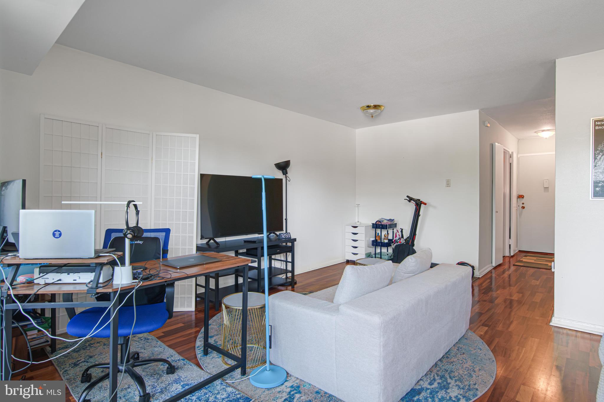 700 7th Street Southwest, Unit 119 Washington, DC 20024 - Photo 5 of 31 a living room with furniture and wooden floor