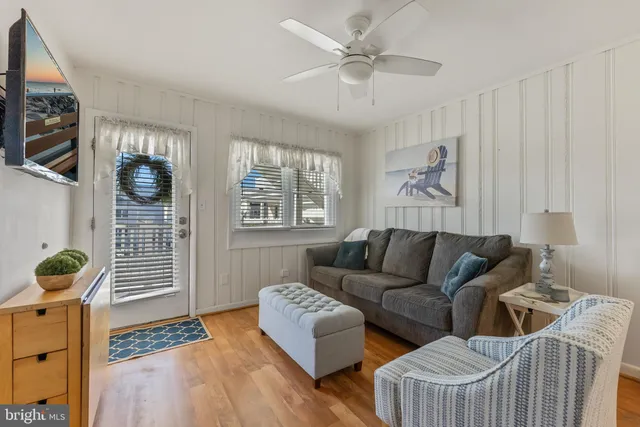 a living room with couches and a flat screen tv