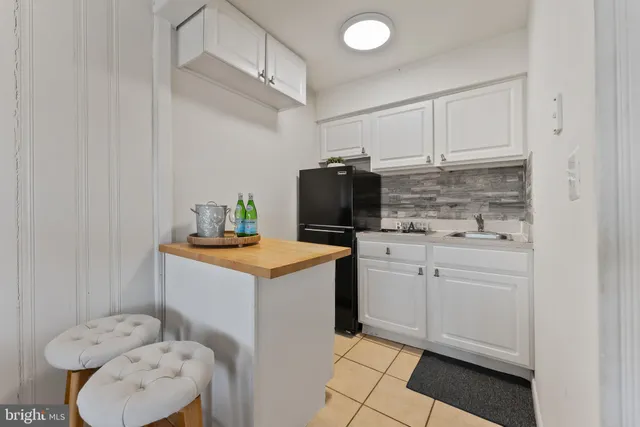 a kitchen with a sink a stove cabinets and utility room