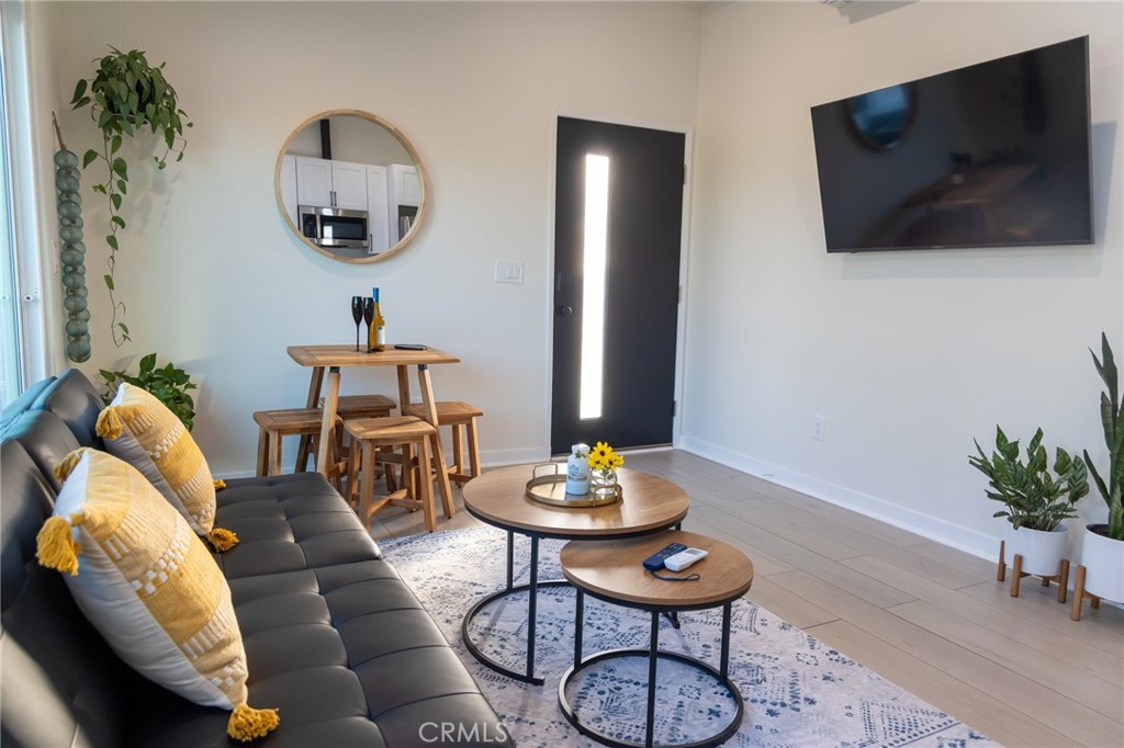 20551 Rhoda Street Woodland Hills, CA 91367 - Photo 2 of 9 a living room with furniture and a flat screen tv