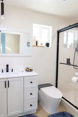 a bathroom with a sink a toilet and a mirror