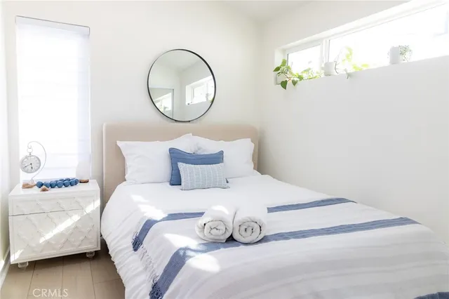 a bedroom with a bed and a painting on the wall