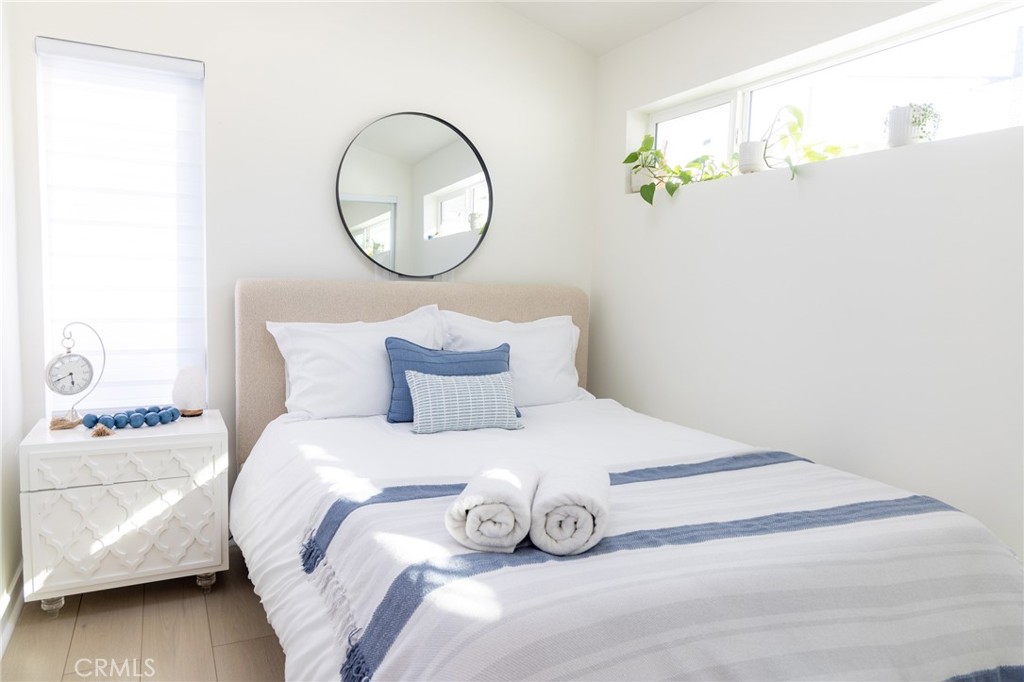 20551 Rhoda Street Woodland Hills, CA 91367 - Photo 6 of 9 a bedroom with a bed and a painting on the wall