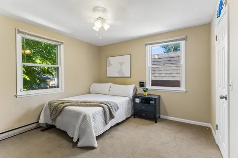 a bedroom with a bed and a tv