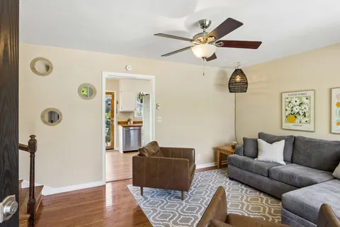 a living room with furniture a chandelier and a window