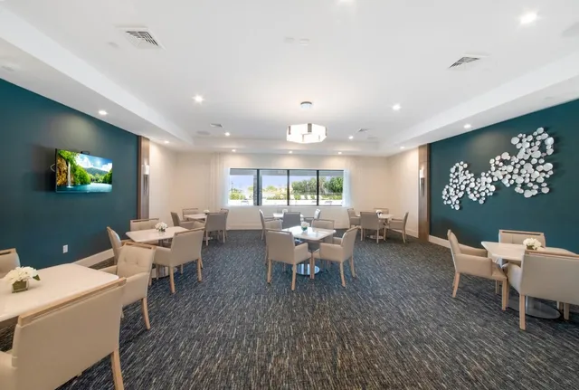 a lobby with furniture and large windows