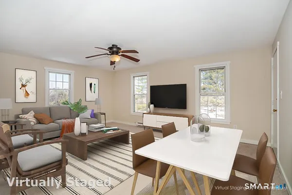 a living room with furniture a chandelier and a flat screen tv