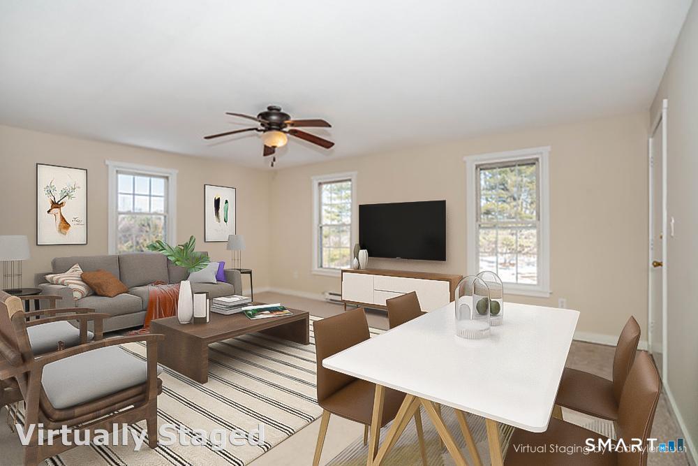 239 Old Farms Road, Unit 7C Avon, CT 06001 - Photo 2 of 17 a living room with furniture a chandelier and a flat screen tv
