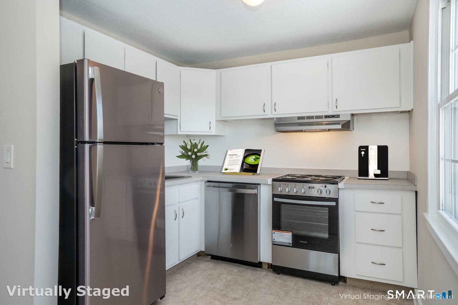 239 Old Farms Road, Unit 7C Avon, CT 06001 - Photo 6 of 17 a white refrigerator freezer and a stove in a kitchen