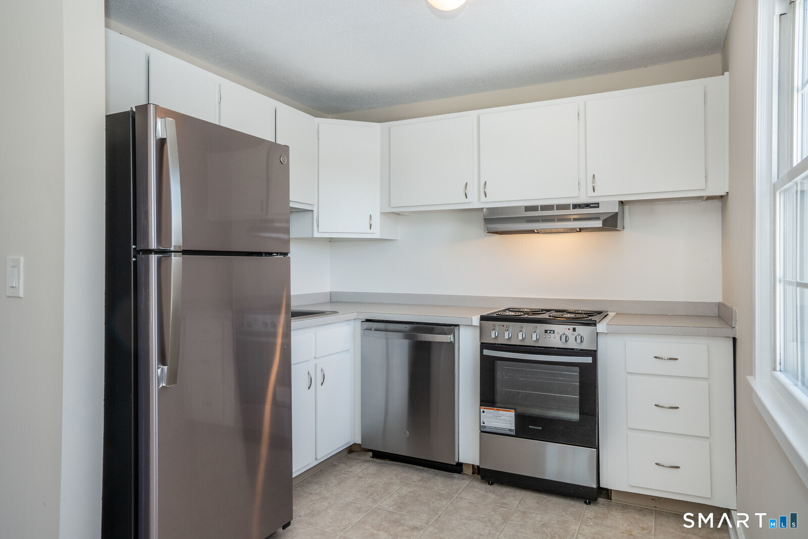239 Old Farms Road, Unit 7C Avon, CT 06001 - Photo 7 of 17 a kitchen with cabinets and a refrigerator