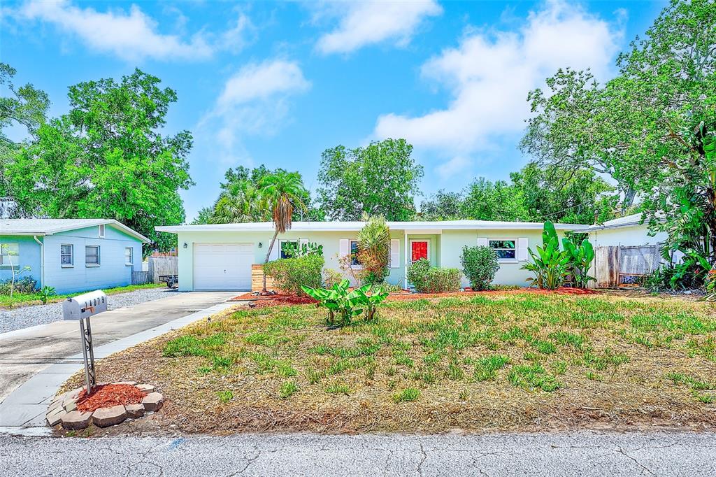 14079 Victoria Road Largo, FL 33774 - Photo 45 of 46 a front view of a house with a yard and garage