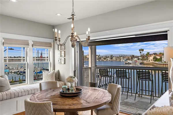a view of a balcony dining space with furniture and city view