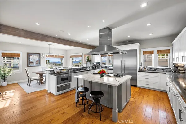 a kitchen with appliances a counter space and a view of living room