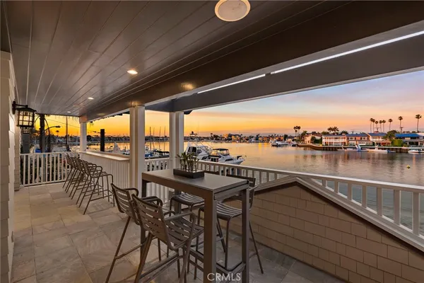 a view of a balcony dining space and swimming pool