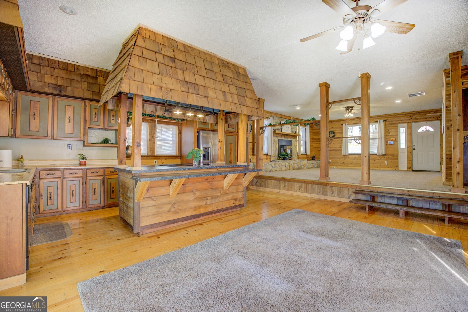 162 Collins Road Jackson, GA 30233 - Photo 27 of 77 a living room with stainless steel appliances kitchen island granite countertop furniture and a kitchen view