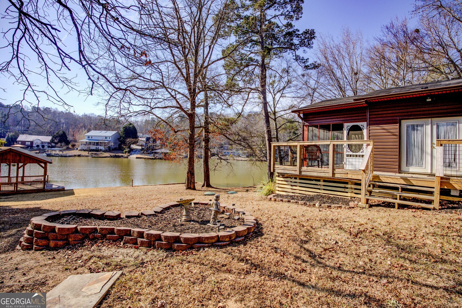162 Collins Road Jackson, GA 30233 - Photo 56 of 77 a front view of a house with a garden and lake