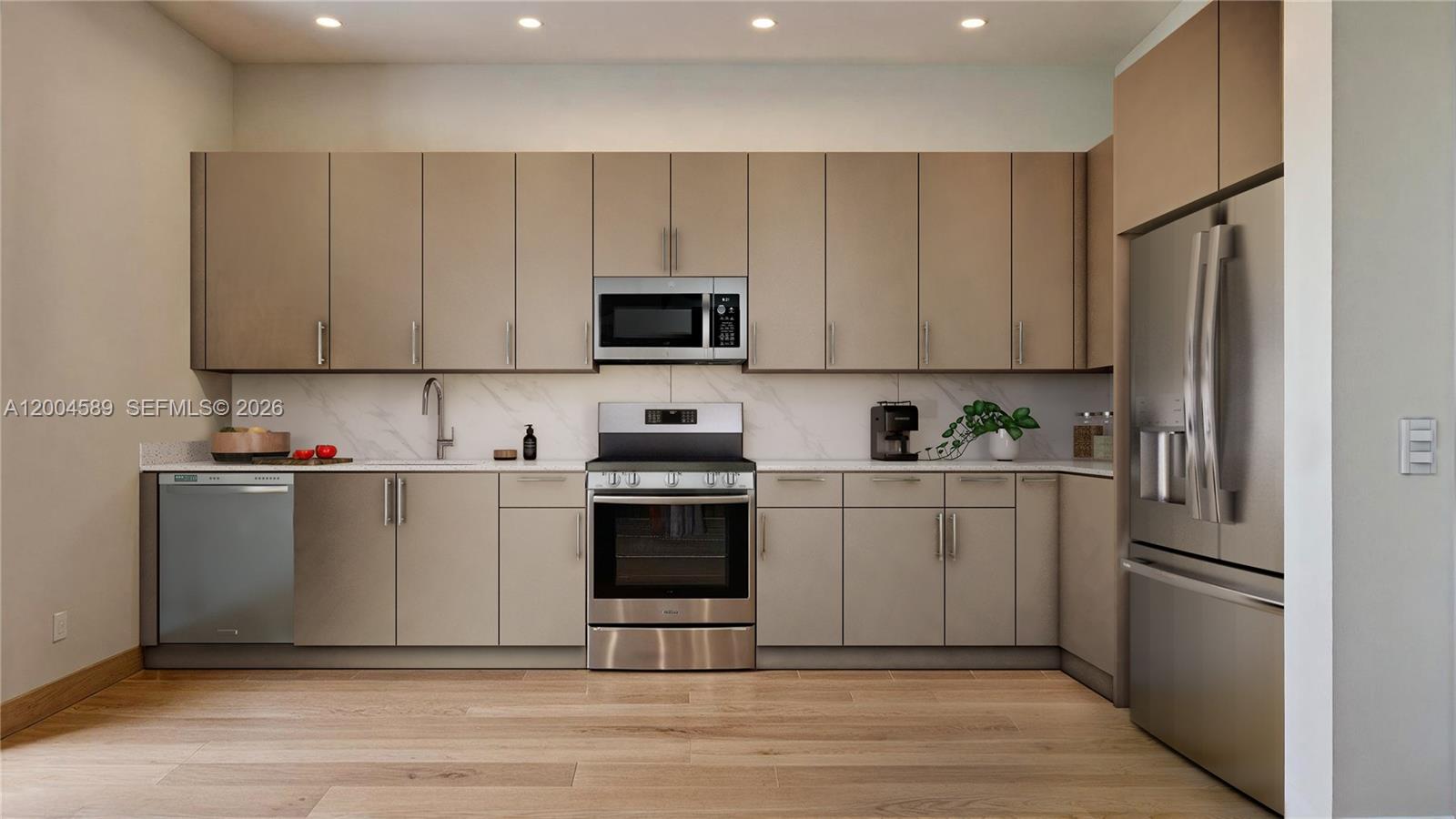 12552 Southwest 194th Street Miami, FL 33177 - Photo 2 of 4 a kitchen with cabinets stainless steel appliances and wooden floor